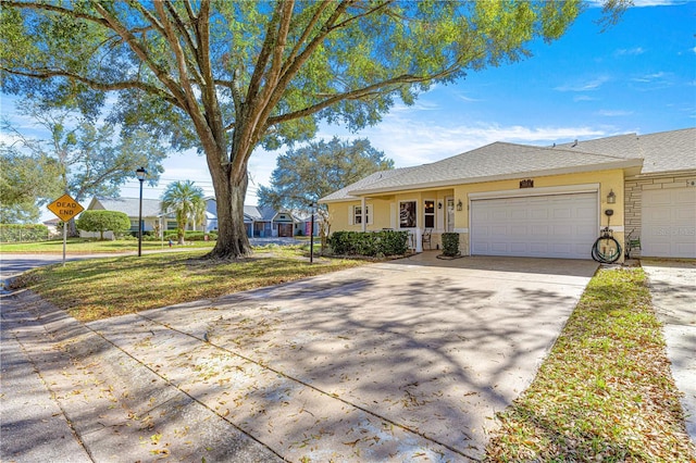 single story home featuring a garage and a front yard