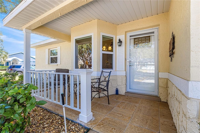 property entrance featuring covered porch