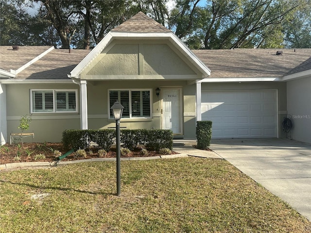 view of front of home with a front lawn and a garage