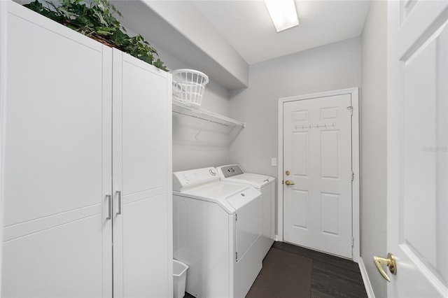 laundry area with separate washer and dryer and dark hardwood / wood-style floors