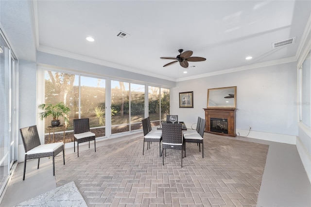 sunroom featuring ceiling fan