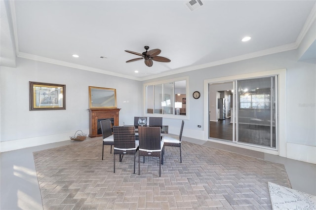 dining space featuring ceiling fan and ornamental molding