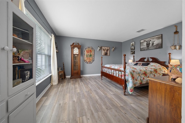 bedroom featuring light wood-style floors, baseboards, and visible vents