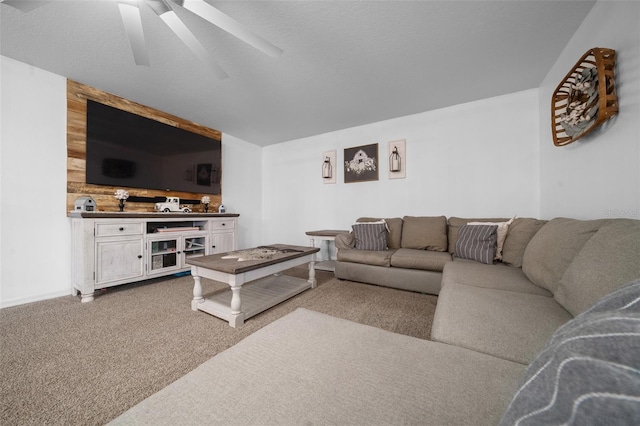 carpeted living area featuring a textured ceiling and ceiling fan