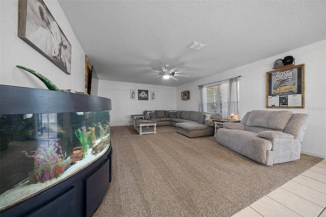 living room featuring light carpet, a ceiling fan, and a textured ceiling