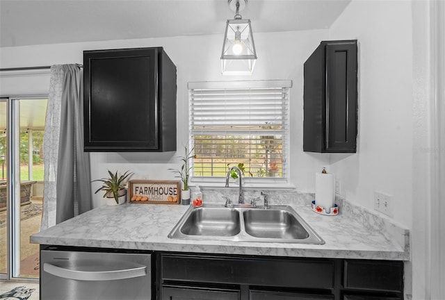 kitchen with a healthy amount of sunlight, light countertops, a sink, and stainless steel dishwasher