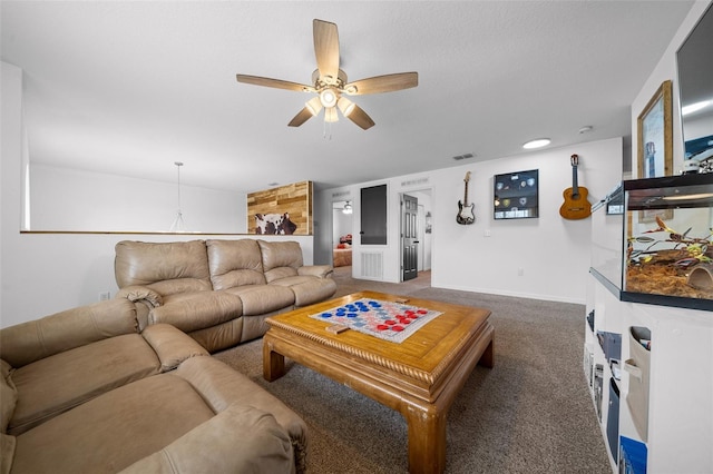 living room with baseboards, visible vents, dark carpet, and a ceiling fan