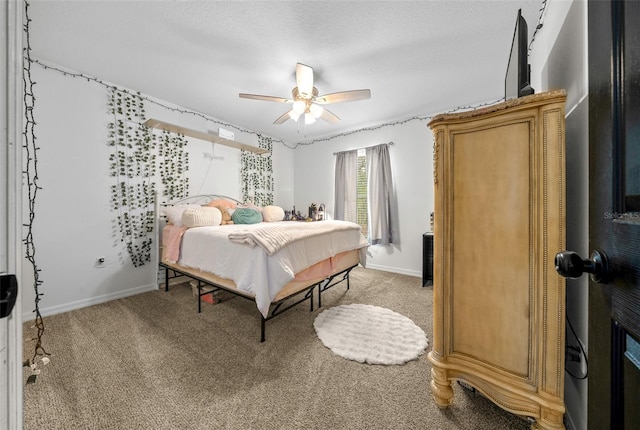 bedroom with light carpet, ceiling fan, a textured ceiling, and baseboards