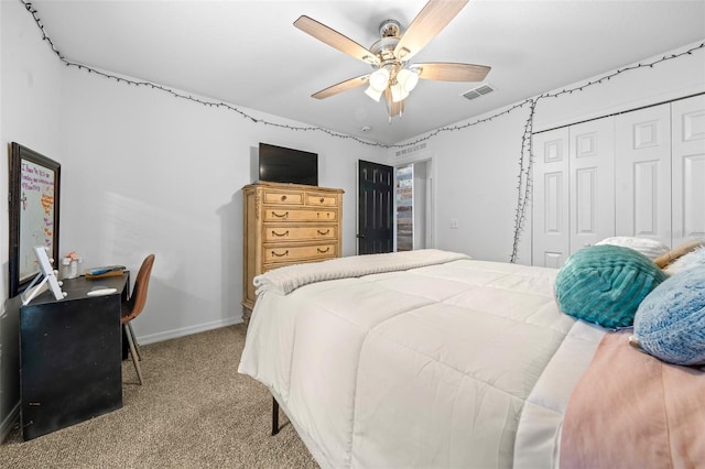 bedroom with light colored carpet, a ceiling fan, baseboards, visible vents, and a closet