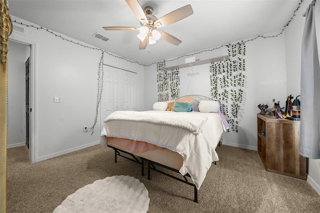 carpeted bedroom featuring a ceiling fan, baseboards, visible vents, and a closet