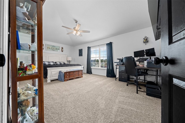 bedroom with vaulted ceiling, a ceiling fan, and light colored carpet