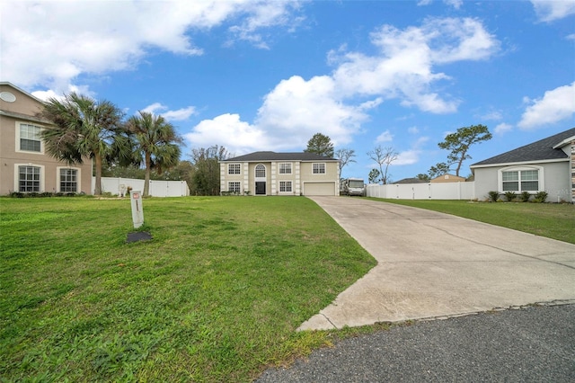 view of front of house featuring driveway, a front lawn, an attached garage, and fence