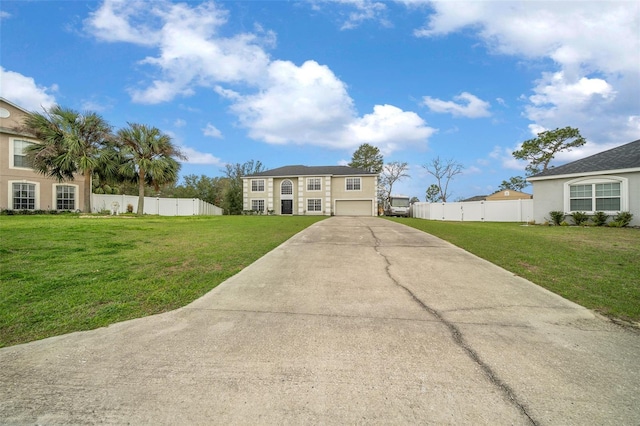 view of front of property featuring driveway, a garage, fence, and a front yard