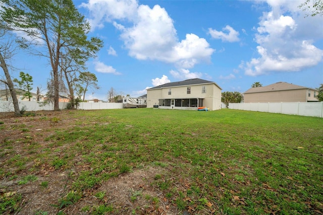 view of yard featuring a fenced backyard and a sunroom