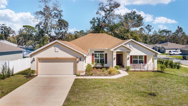 view of front facade featuring a front yard, fence, an attached garage, stucco siding, and concrete driveway