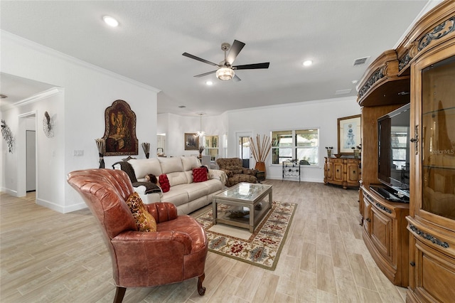 living area featuring crown molding, light wood finished floors, visible vents, ceiling fan, and baseboards