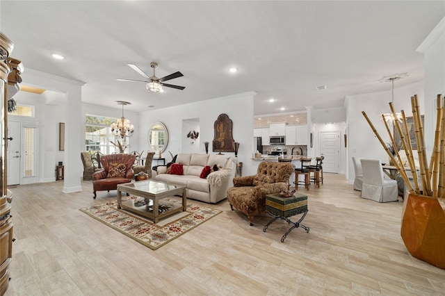 living area with light wood-type flooring, recessed lighting, crown molding, and ceiling fan with notable chandelier