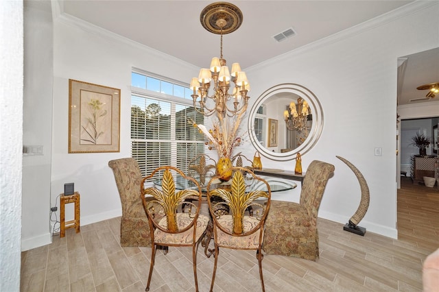 dining area with wood finish floors, visible vents, baseboards, an inviting chandelier, and crown molding