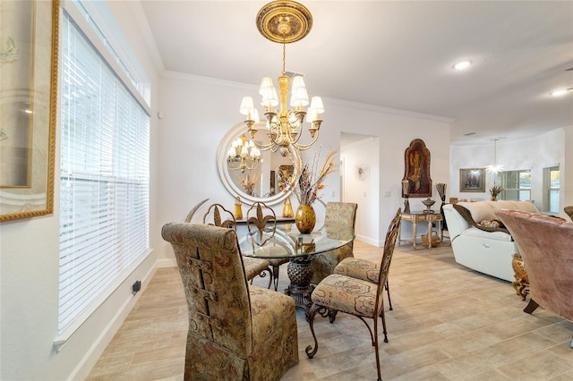 dining area featuring light wood-style floors, crown molding, baseboards, and an inviting chandelier