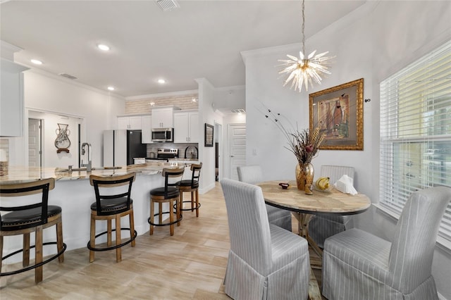 dining area with ornamental molding, recessed lighting, and a notable chandelier