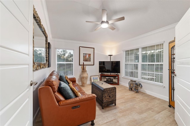 living room with baseboards, light wood-style flooring, ornamental molding, and a ceiling fan