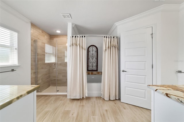 full bathroom with visible vents, wood finished floors, vanity, and crown molding