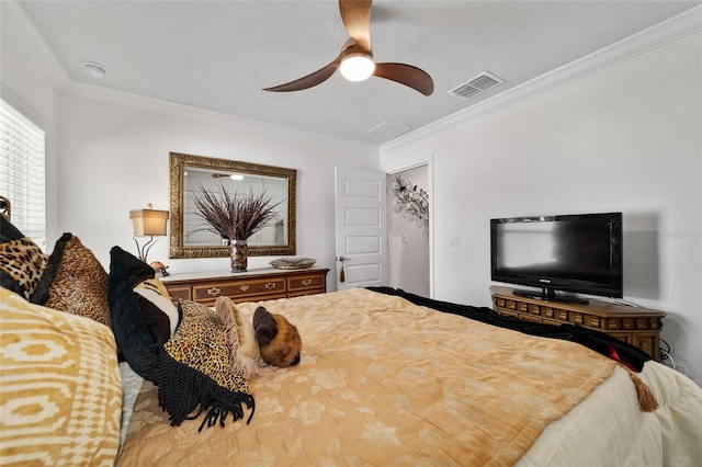 bedroom with ornamental molding, visible vents, and ceiling fan