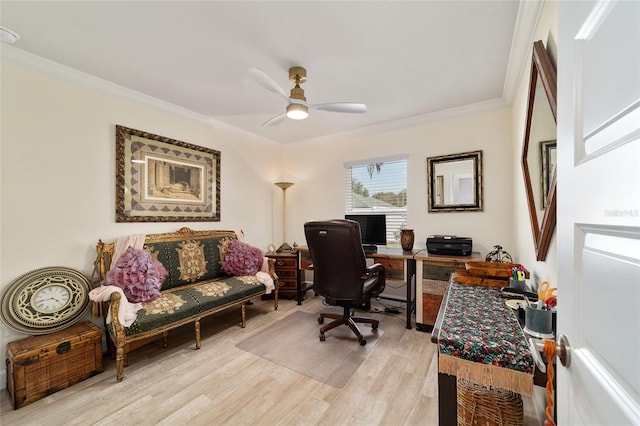 office space with crown molding, light wood-style flooring, and ceiling fan