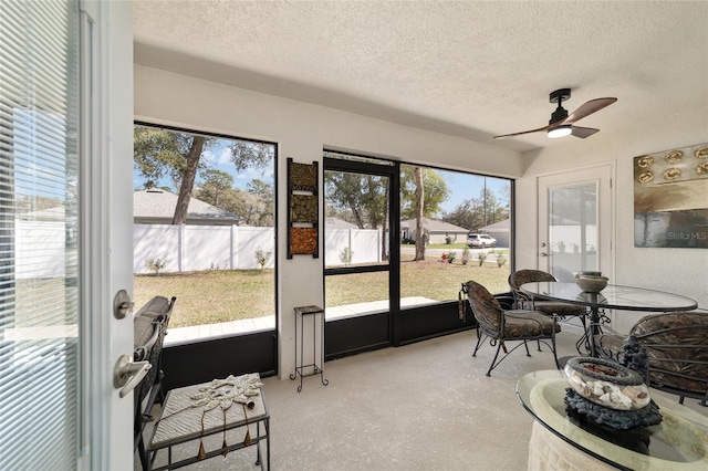 sunroom / solarium featuring ceiling fan