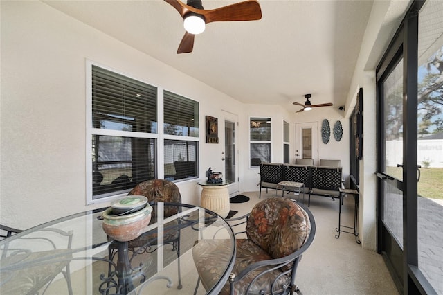 sunroom featuring a ceiling fan