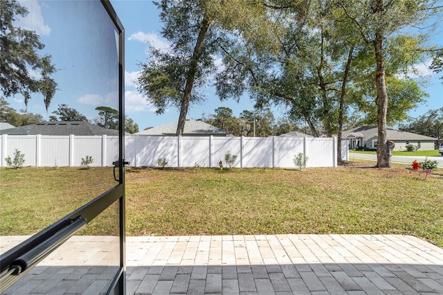 view of yard with fence and a patio