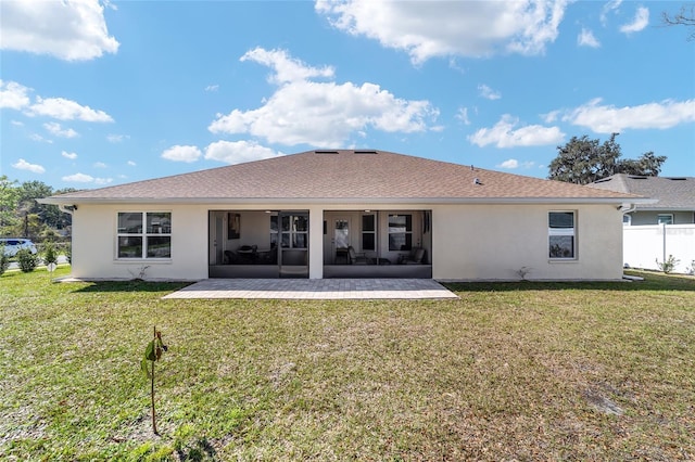 back of house with a patio, fence, a sunroom, a lawn, and stucco siding