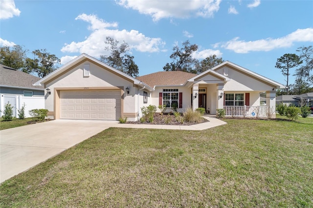 view of front of property featuring an attached garage, covered porch, driveway, stucco siding, and a front lawn