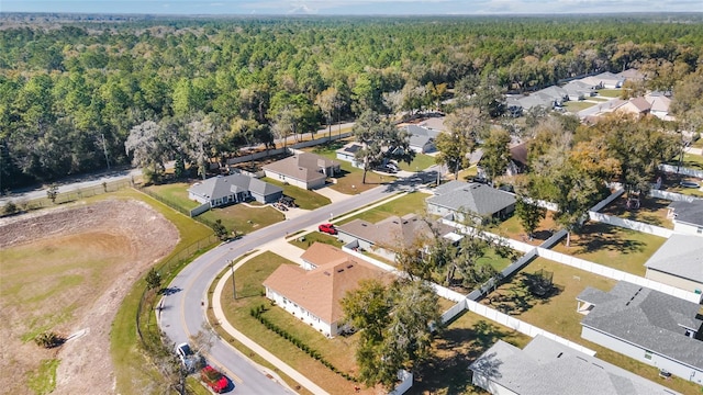 drone / aerial view with a residential view and a view of trees