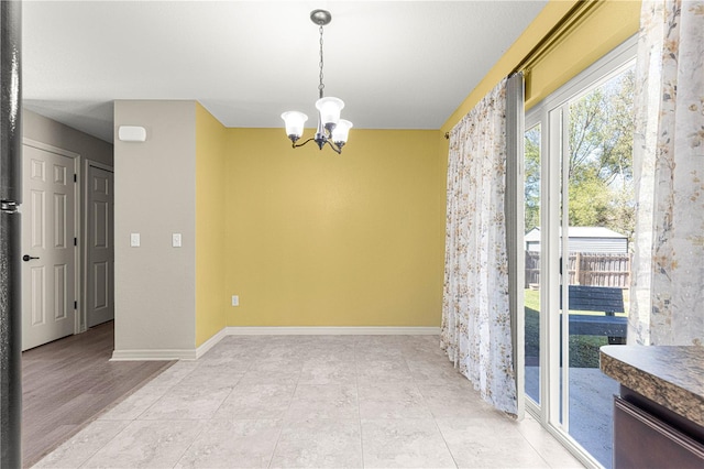 unfurnished dining area with a notable chandelier