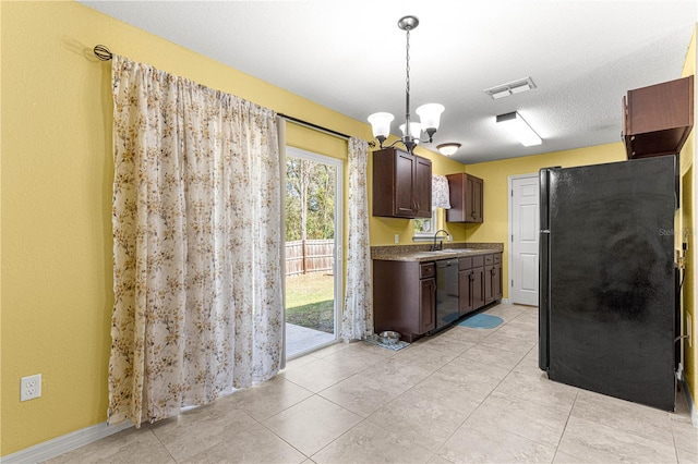 kitchen featuring black refrigerator, hanging light fixtures, a notable chandelier, sink, and dishwasher