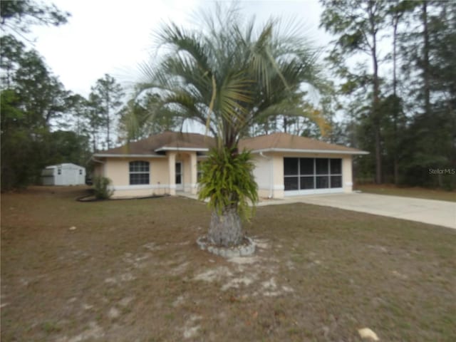 single story home featuring a front yard and a garage