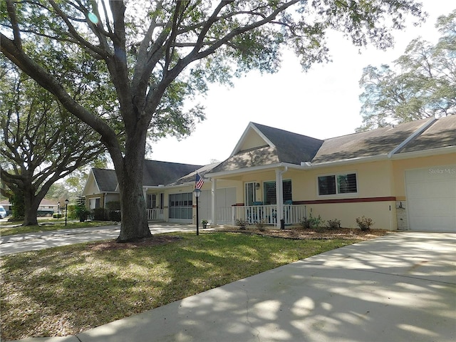 view of front of home with a front yard and a garage