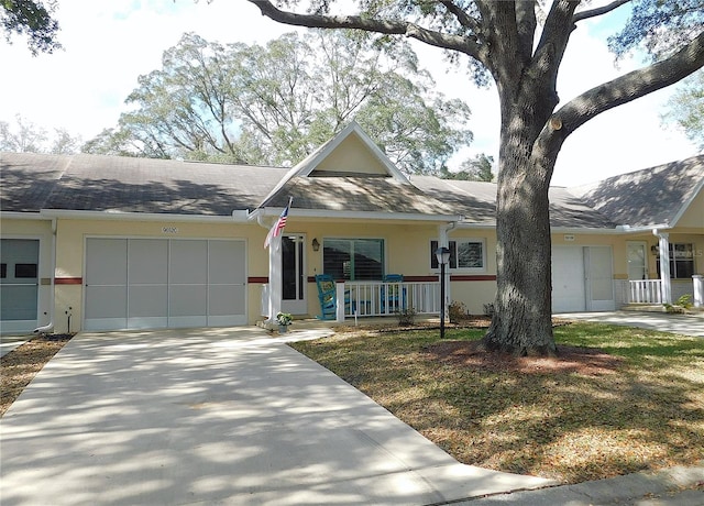 single story home with a porch and a garage