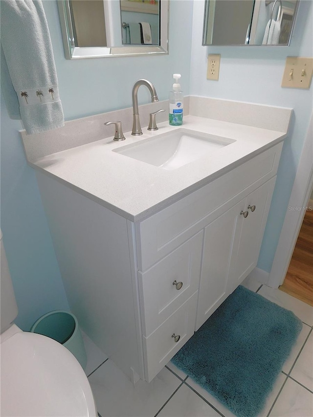 bathroom with tile patterned floors, toilet, and vanity