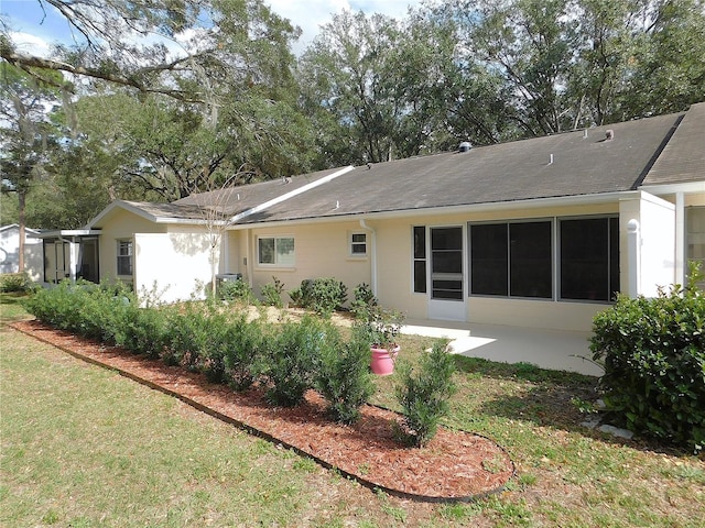 back of house with a yard and a patio area