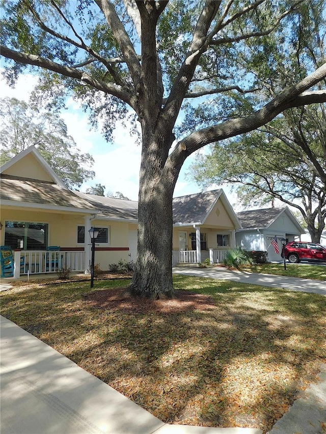 single story home with covered porch and a front lawn