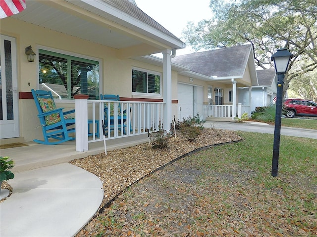 view of property exterior with a garage and a porch