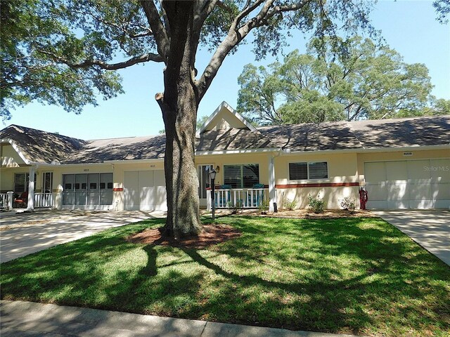 9652 SW 84th Ter Unit C, Ocala, FL 34481 - ranch-style house featuring a garage, concrete driveway, a porch, and a front yard