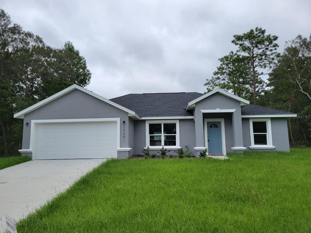 ranch-style house with a front yard and a garage