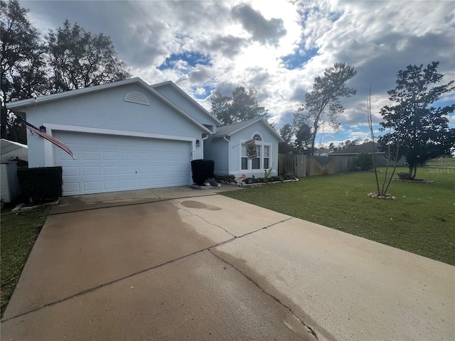 single story home featuring stucco siding, concrete driveway, a front yard, fence, and a garage