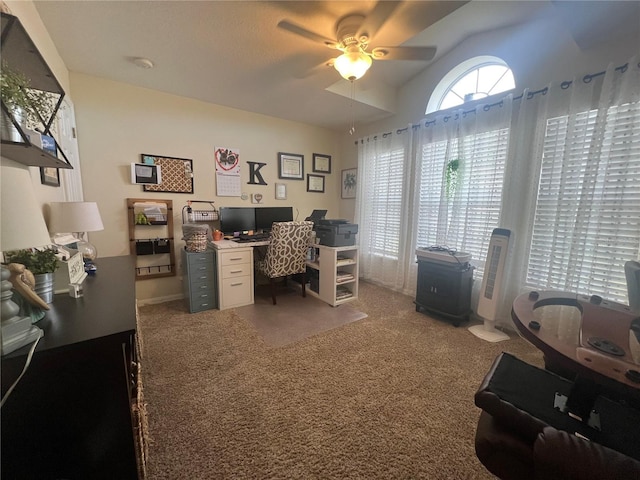 home office with lofted ceiling, a ceiling fan, and light colored carpet