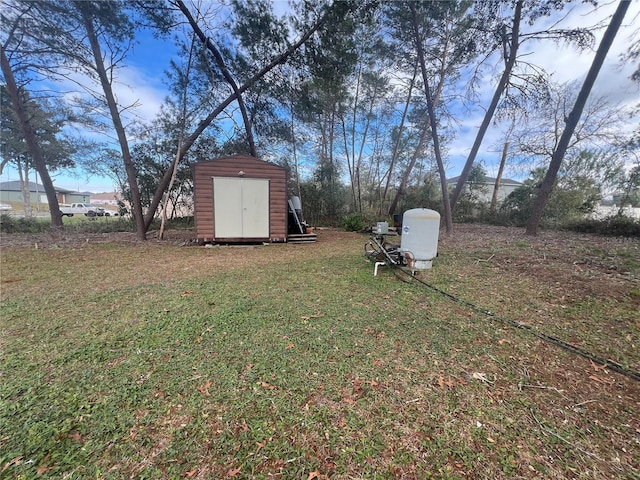 view of yard with a storage shed and an outbuilding