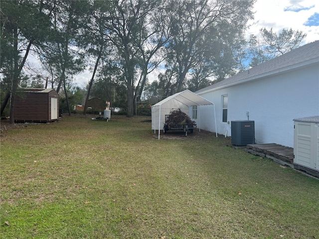 view of yard featuring a storage shed, central AC, and an outbuilding