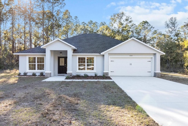 view of front facade with a front lawn and a garage